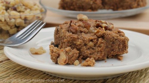 Cinnamon bar with walnuts and more cinnamon bars in background.