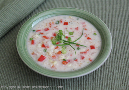 Creamy corn chowder with fancy green onion garnish.