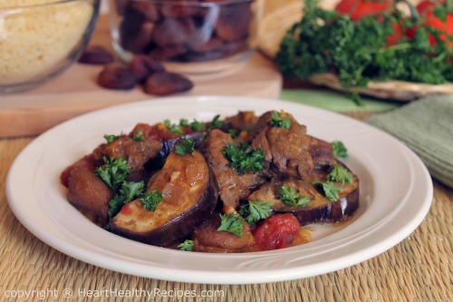 Apricot lamb dish with eggplant, tomatoes and garnished with fresh parsley.