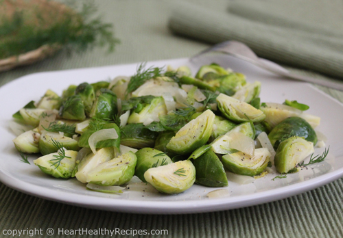 Brussels sprouts garnished with dill weed sprigs.