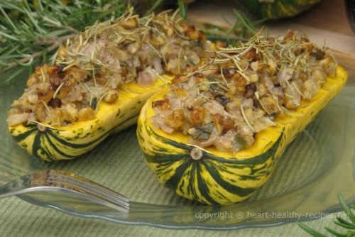 Two stuffed Delicata squashes with rosemary bunches in background.