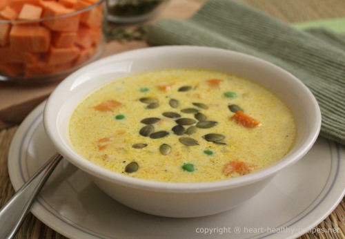 Sweet potato chowder garnished with pumpkin seeds.