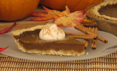 Egg-free pumpkin pie with cinnamon sticks.