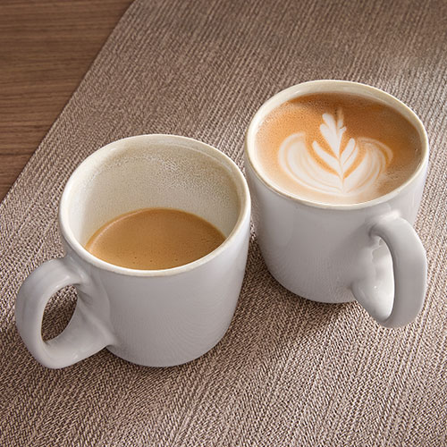 2-Piece Mug Set with hot beverage inside on a tan placemat.