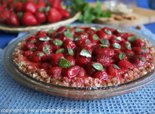 No-bake strawberry pie topped with individual mint leaves.