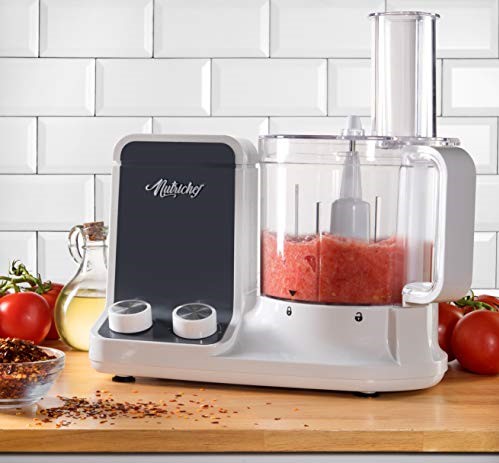 Ultra quiet food processor surrounded by red tomatoes and red pepper.