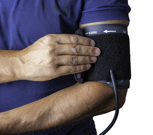 Man checking blood pressure for Men's Heart Health.