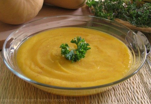 Butternut squash soup in serving bowl garnished with parsley.